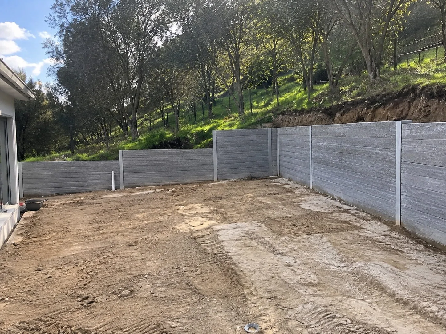 Concrete sleeper retaining wall set between posts in Christchurch